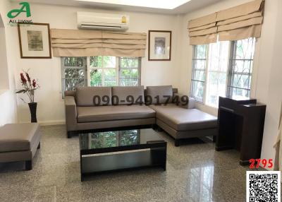 Spacious and well-lit living room with modern furniture and air conditioning