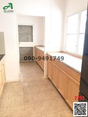 Spacious kitchen with ample cabinetry and tiled flooring