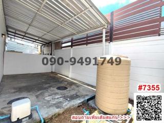 Spacious garage with roof and water tank