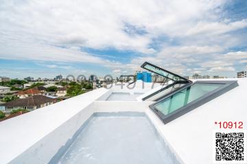 Spacious roof terrace with open skylight and panoramic city views