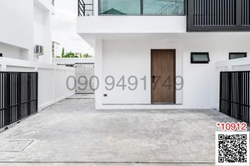 Modern two-story residential building with a spacious driveway