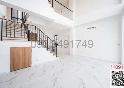 Bright and spacious interior with staircase and marble flooring