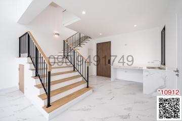 Modern entrance hall with staircase and marble flooring