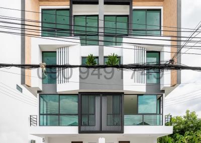 Modern Multi-Story Apartment Building Facade with Balconies and Garage