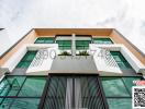 Modern building exterior with green plants and a stylish front