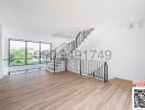 Spacious and well-lit living room with staircase and balcony