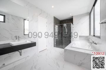 Modern bathroom with marble finish and large window