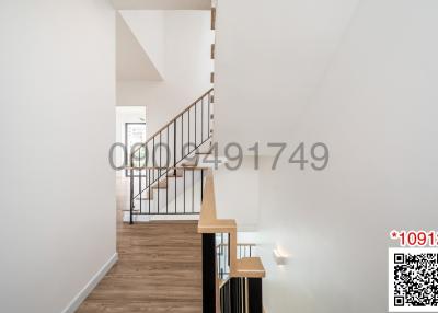 Bright and modern hallway with staircase and hardwood floors