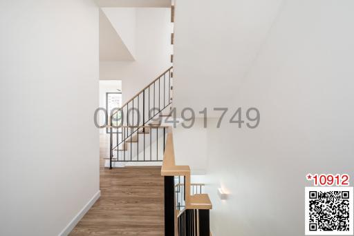 Bright and modern hallway with staircase and hardwood floors