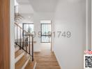 Spacious and bright hallway with wooden flooring and stair access