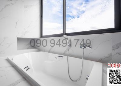 Modern bathroom with white marble walls and a large bathtub