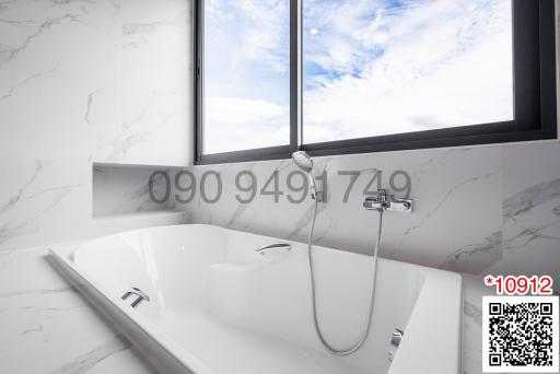 Modern bathroom with white marble walls and a large bathtub