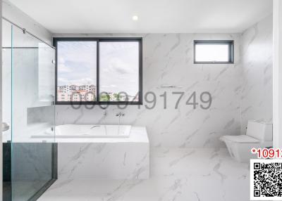 Modern bathroom with marble tiles, large windows, and glass shower