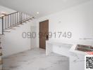 Modern kitchen with marble flooring and wooden staircase