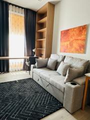 Modern living room interior with sofa, artwork, and large window