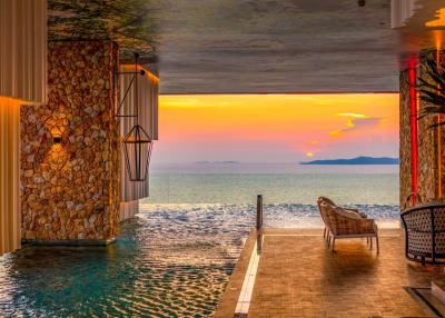 Luxurious outdoor pool overlooking the ocean at sunset