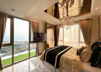 Luxurious bedroom with an ocean view, elegant decor, and natural lighting