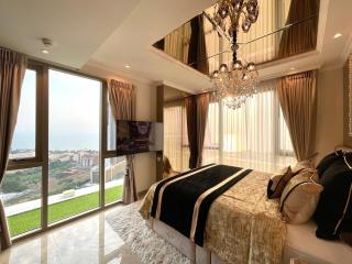 Luxurious bedroom with an ocean view, elegant decor, and natural lighting