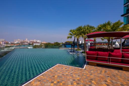 Luxurious infinity pool with city views and lounge area