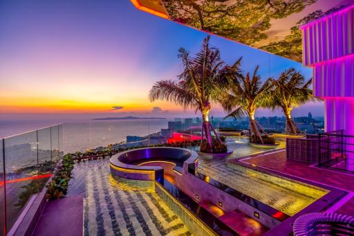 Luxurious rooftop terrace with infinity pool and panoramic city view at sunset