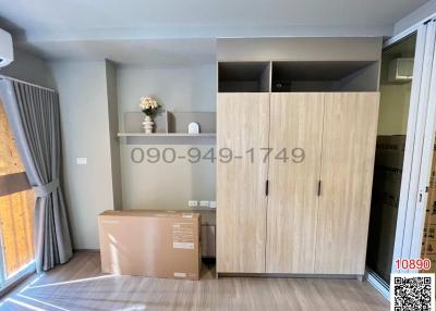 Compact bedroom with wooden wardrobe and packaged furniture