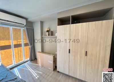 Bright bedroom with large wardrobe and glass door