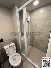 Compact bathroom with shower enclosure and toilet