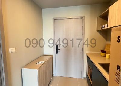 Compact building entrance area with shoe rack and kitchenette