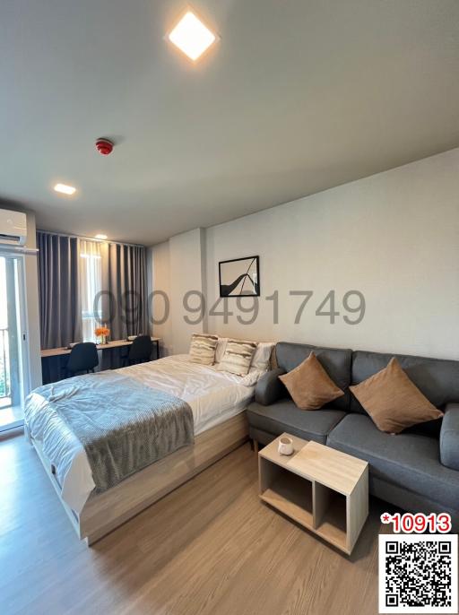 Modern bedroom with large bed and comfortable sofa