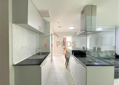 Modern kitchen with stainless steel appliances and white cabinetry