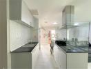 Modern kitchen with stainless steel appliances and white cabinetry