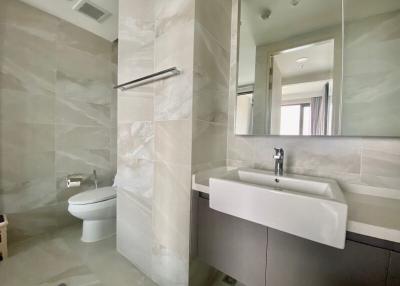 Modern bathroom with wall-mounted sink and toilet