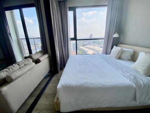 Modern bedroom with large windows and city view