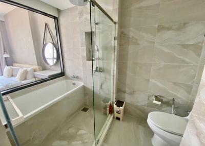 Modern bathroom with glass shower enclosure and bathtub
