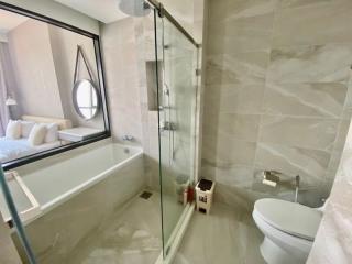 Modern bathroom with glass shower enclosure and bathtub