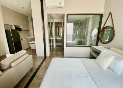 Modern bedroom with an en-suite bathroom, comfortable double bed, and compact kitchenette