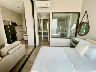 Modern bedroom with an en-suite bathroom, comfortable double bed, and compact kitchenette