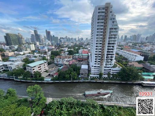 Panoramic city view with river and passing boat from high-rise apartment balcony