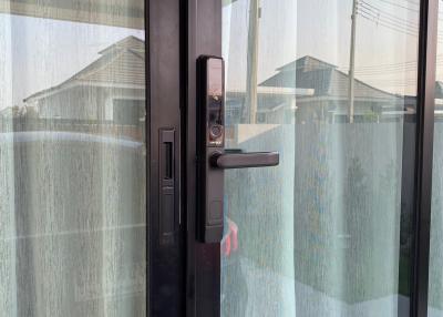 Modern entrance door with digital lock system and textured glass for privacy