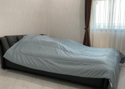 Spacious bedroom with large bed and modern air conditioning unit