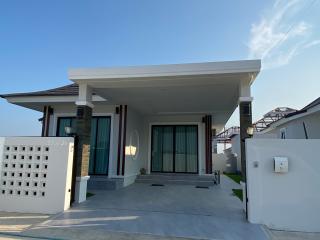 Modern single-family home exterior with clear blue sky