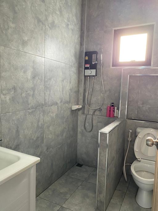 Modern bathroom with grey tiles and essential fixtures