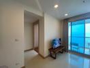 Bright and spacious living room with an ocean view through sliding glass doors