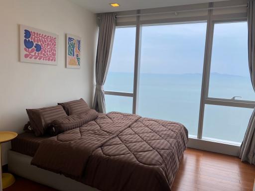 Cozy bedroom with a large bed and ocean view