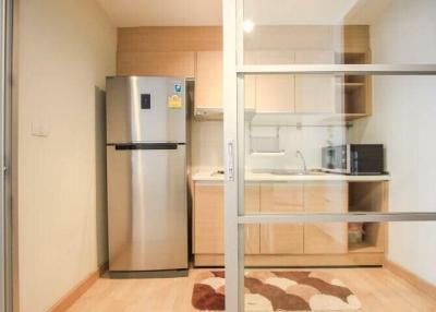 Compact kitchen with modern appliances and wooden cabinetry