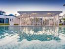 Luxurious outdoor swimming pool with white cabana and modern house facade