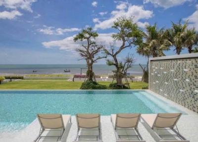 Luxurious outdoor pool overlooking the beach with lounge chairs
