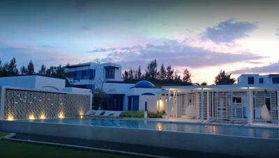 Luxurious house exterior with pool at twilight