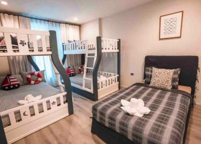 Spacious bedroom with a double bed and bunk beds