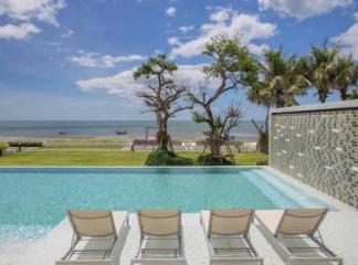 Luxury pool with ocean view and lounge chairs